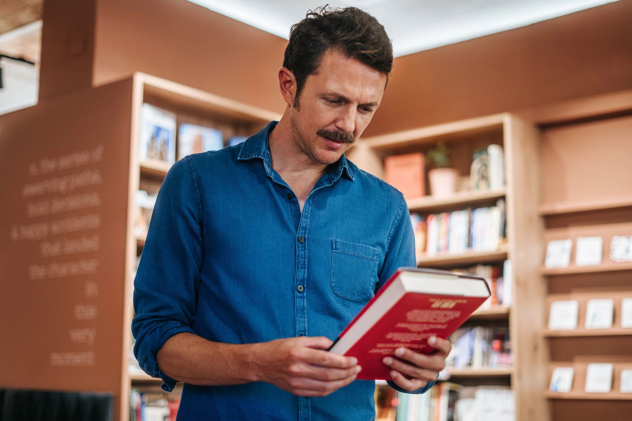 Scholar examining a book in a library setting