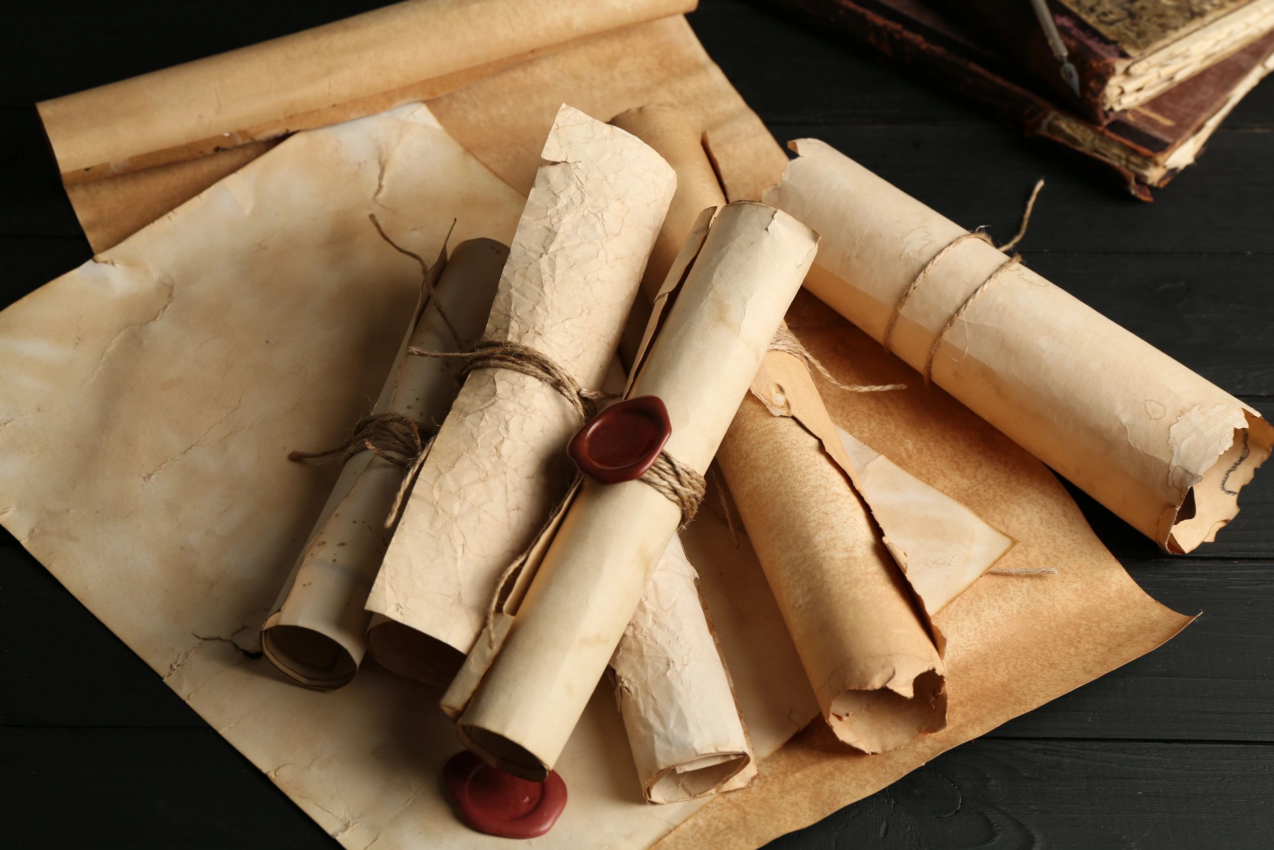 Grouped antique scrolls on a dark table