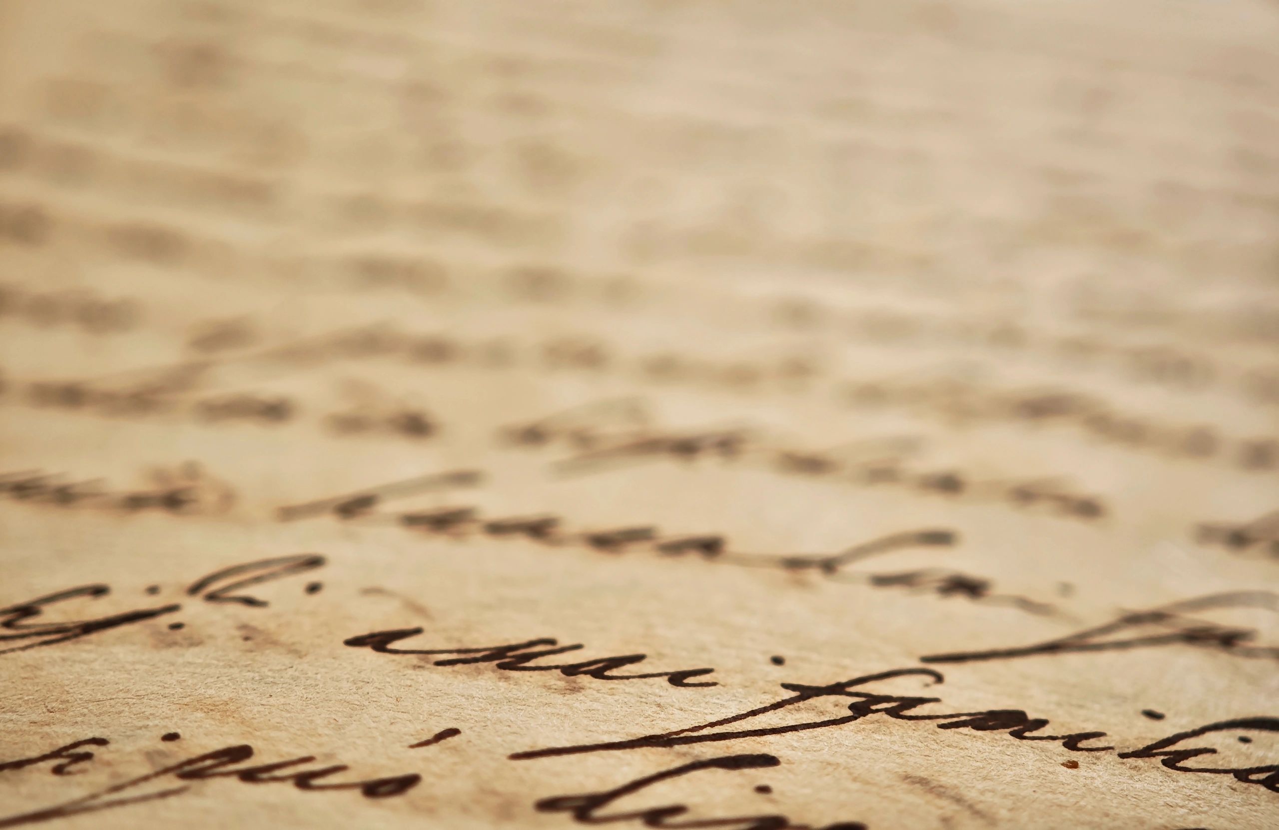 Close view of an old handwritten manuscript with ink script on aged paper