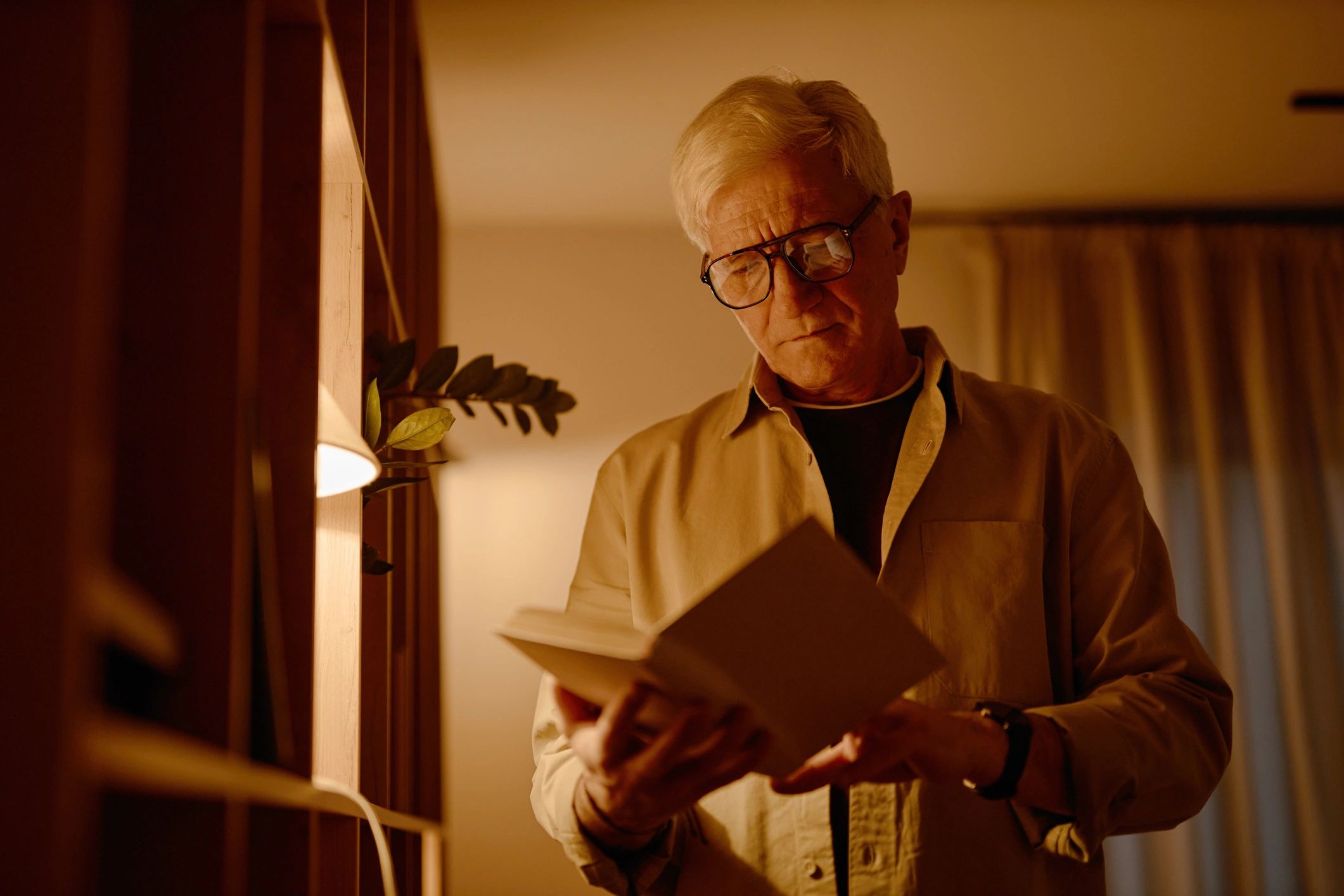 Researcher reading a book beside shelves